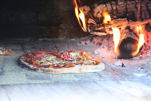 A pizza bakes inside the Mile End Bread Oven. Volunteers with the bread oven say they want to preserve traditional ways of preparing food. Just a few blocks away, the famed St-Viateur Bagel shop still uses a wood-fire oven.