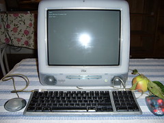 An apple next to an Apple iMac