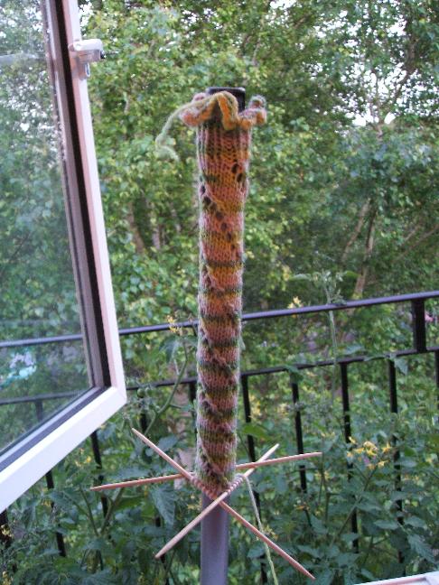 Knitted walking stick cosy