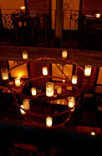 Large candlelit chandeliers hanging