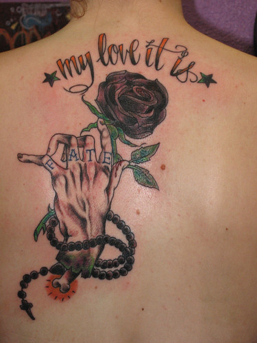 blackrose the tattoo is not crooked it is centered by the lettering on her