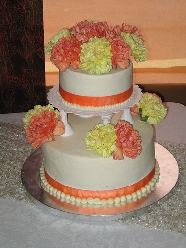 Variegated carnations in sunny yellow and coral top almondflavored layers