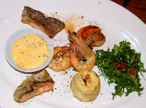 Hot Seafood Plate featuring scallops, prawn, fish and a rocket and tomato salad served with bernaise sauce