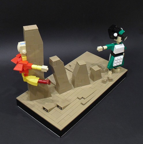 A picture of a Lego sculpture featuring a Toph-like character raising up brown stones. An Aang figure crashes into one of the earth structures. 