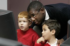 Culture Minister David Lammy tries out the new web site with some help form Alistair (on left) from St George The Martyre School and his friend.