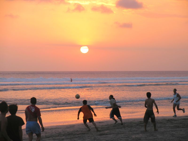 Kids playing soccer on Seminyak beach