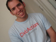 Photo of Gregory Heller smiling in a CivicActions Empowered T-shirt