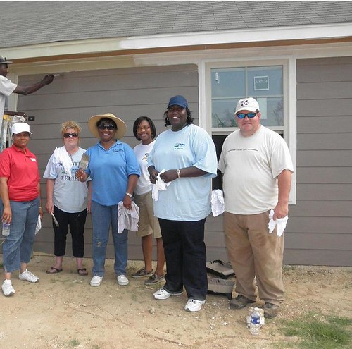 Mississippi Rural Development State Director Trina George (second from right) and a crew of USDA Rural Development employees pose in front of an almost completed wall. The crew was part of a team of painters helping to repair and repaint a Yazoo City home damaged by the recent tornado. 