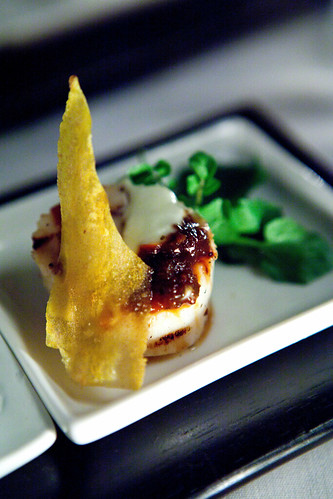 Grilled scallop with sweet chili sauce, crème fraiche and green plantain crisp