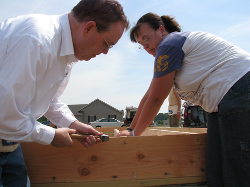 USDA Rural Development Under Secretary Dallas Tonsager hammers a nail into the floor joists of Dennis and Suzanne Passwater's new home.  The Passwaters have wanted a home of their own for 16 years and with support from USDA and their own hard work they will have one. 