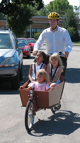 Three children in a bakfiets cargo bike