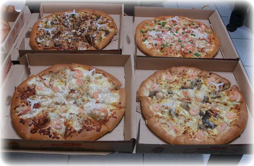 three different kinds of seafood pizza and one black pepper beef pizza