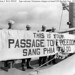 98 Four crewmen display a welcoming banner for Vietnamese refugees coming on board USS Bayfield (APA-33) for passage to Saigon, Indochina, from Haiphong, 3 September 1954. by manhhai