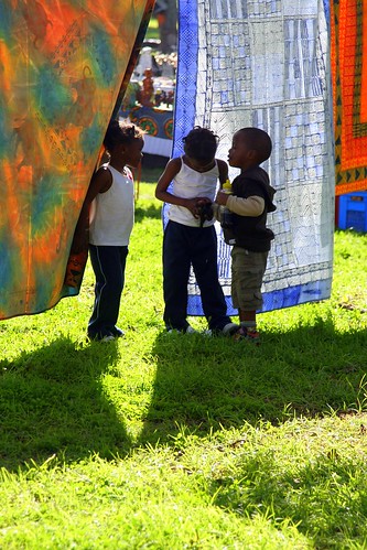 CHILDREN PLAYING IN THE BATIKS AT THE MARKET