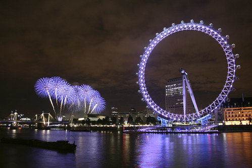 london eye at night with fireworks. The London Eye at night on the
