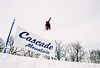 A skier gets air over sign at Cascade Mountain