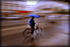 cycling with an umbrella - by eir@si