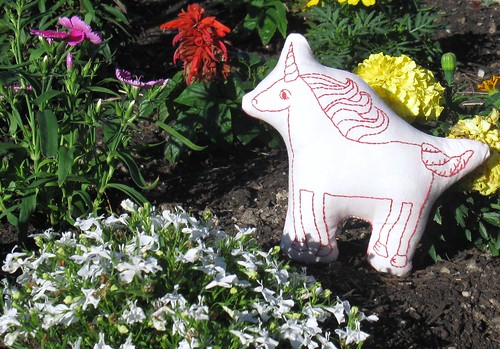 Unicorn frolics in the flower beds.