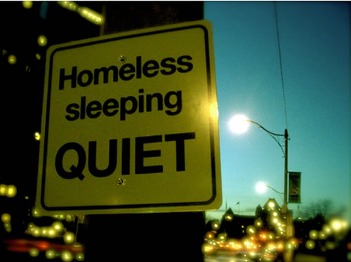 homeless-sleeping-quiet-sign