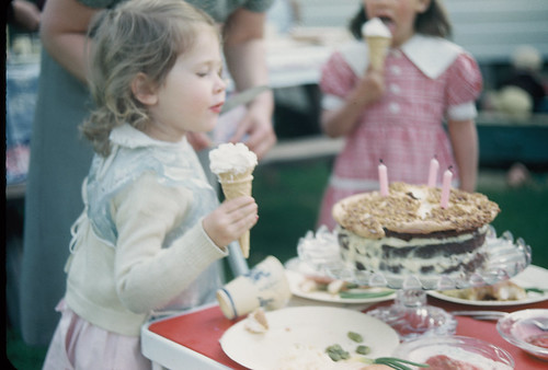 Jan eats an ice cream cone at her 3rd birthday party