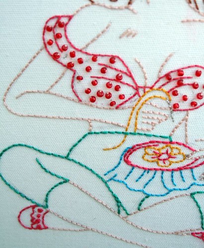 Up close embroidering pin-up