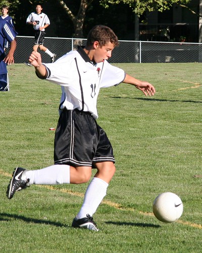 Andrew kicks the ball.