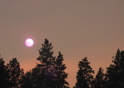 Setting sun, obscured by red smoke
