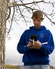student recording in a field journal for a tree survey
