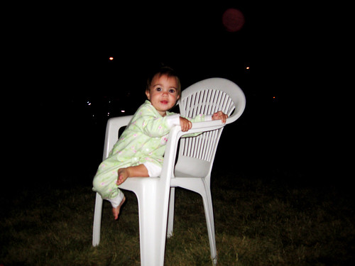 Enjoying the fireworks and sitting all by herself