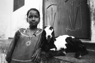 an Indian girl with a goat