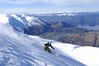 A skier takes a powder run in scenic Treble Cone, NZ