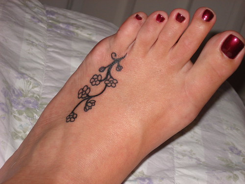 girly tattoos on feet. Pretty Flower Foot Tattoo