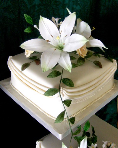 Simply elegant cake topped with gumpaste cascade bloom consist of lilies
