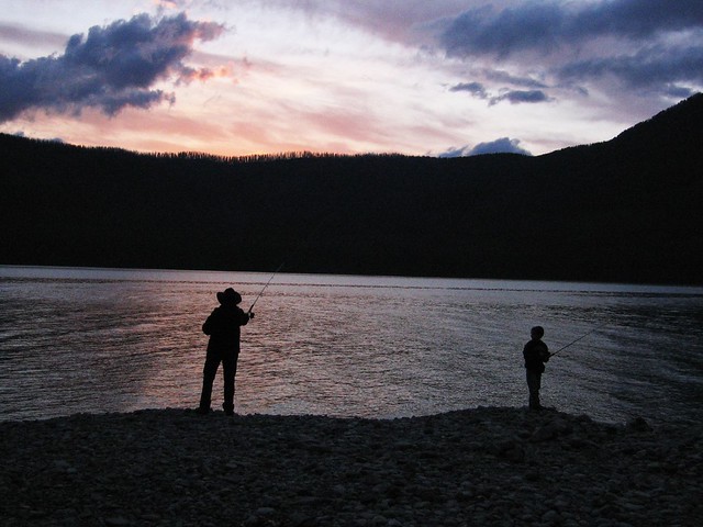 Sunset Father-son fishing in Lake McDonald, Glacier Park, MT