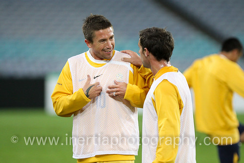 Harry Kewell and Scott McDonald engage in conversation during training.