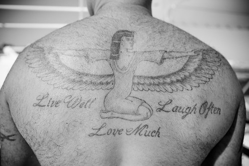Live Love Laugh A tattoo on the back of a young woman diver 