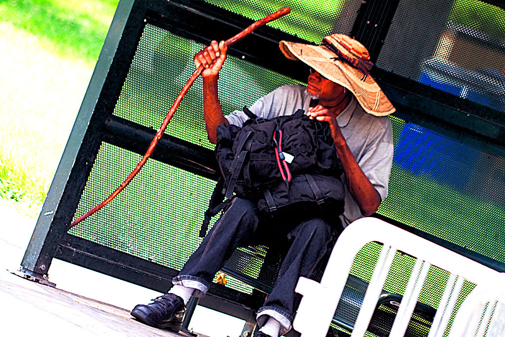 Man-at-bus-stop-with-cane--Denver