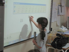 Student using a interactive white board for math lesson at Ahliyyah School for Girls by inveneo