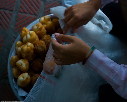 Woman selling doughnuts in Hanoi, Vietnam
