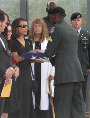 Salette Latas receives the American flag at Jesse's funeral.