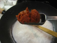 Adding red curry paste