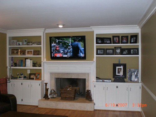 TV on the wall over fireplace