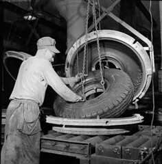 Workman removes a synthetic rubber tire from t...