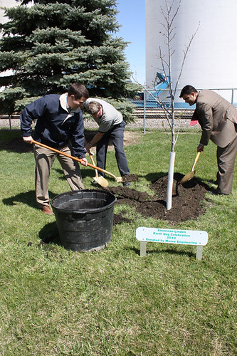 North Dakota Rural Development State Director Jasper Schneider (left) shovels during a tree planting ceremony celebrating Earth Day 2010, in Finley, ND. Assisting are Finley Mayor Larry Amundson (center) and Special Assistant for Rural Utilities John Padalino (right). 