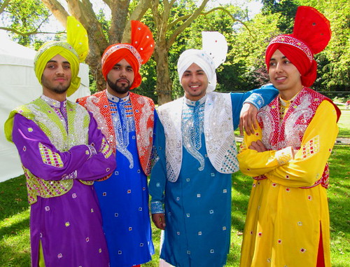Four Indian young men in traditional men's wedding clothes