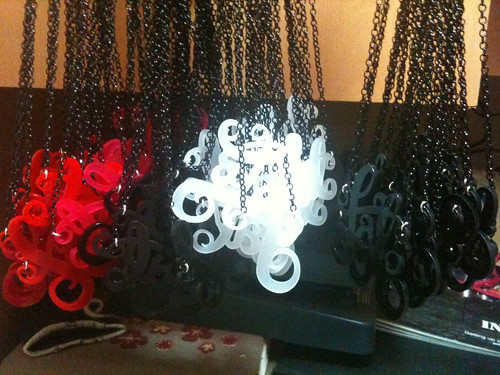 Photo of lots of my fat necklaces hanging in bunches of colours, red, white, pink and black.