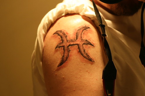 Symbol of pisces designs tattoo or arm