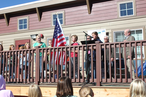 Students recite the Pledge of Allegiance at the start of a ceremony for the new school project