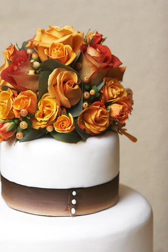 The top of a fancy wedding cake with flowers