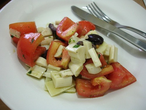 Tomato, hearts of palm, olive and parmesan salad with basil dressing